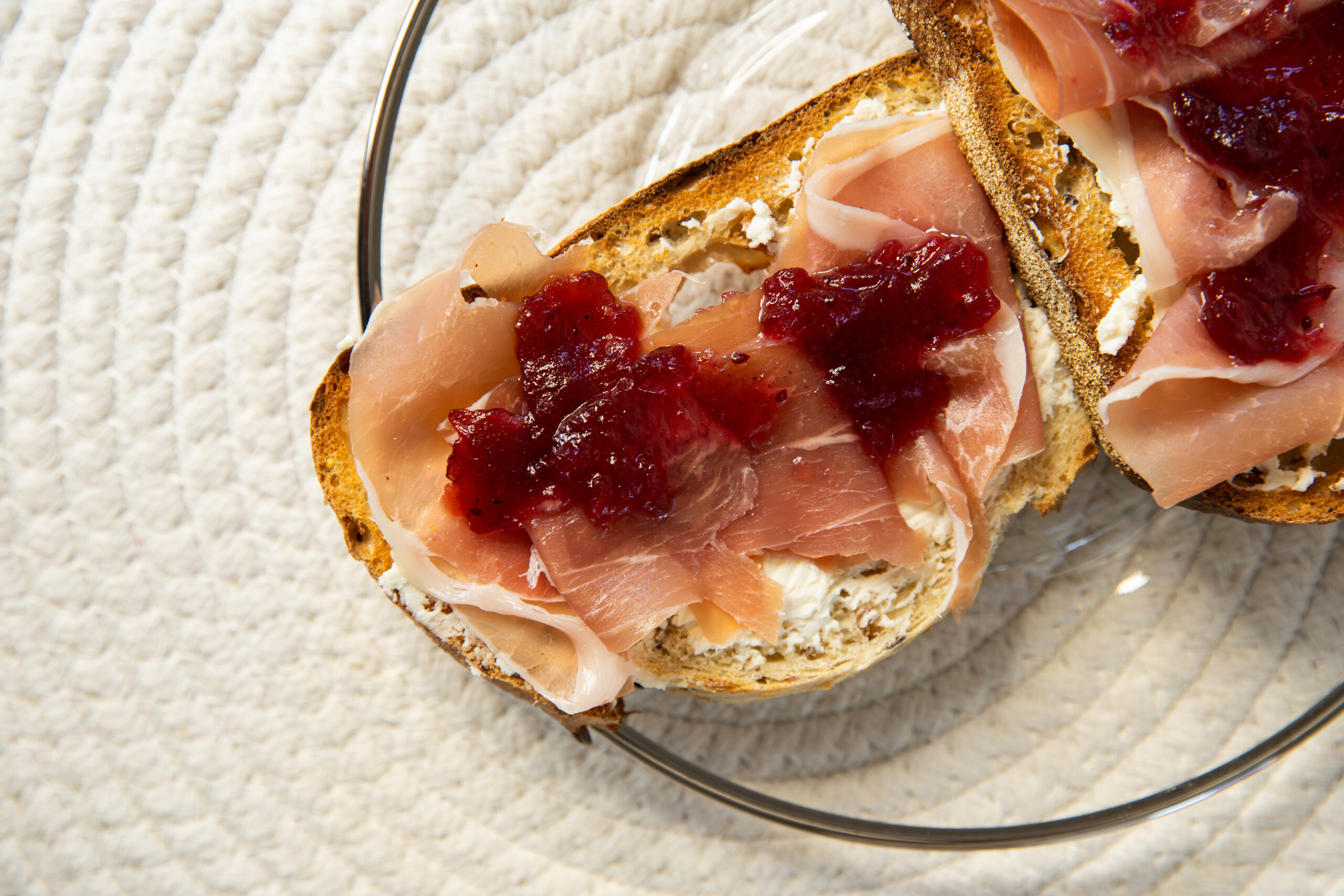 Toasted Honey Grain bread with ricotta, cranberry jam, and prosciutto.